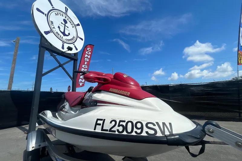The Image of 1999 Sea Doo Jet Ski on display at a consignment shop under a clear blue sky. - 0
