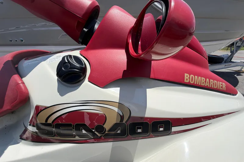 Slide: The Image of 1999 Sea Doo Jet Ski by Bombardier, featuring red and white design with logo. - 14