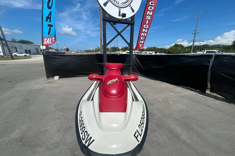 Slide: The Image of 1999 Sea Doo Jet Ski on display at a boat sale, sunny day background. - 16