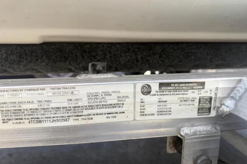 Slide: The Image of Label on a Triton Trailers frame, detailing specifications and tire information. - 23