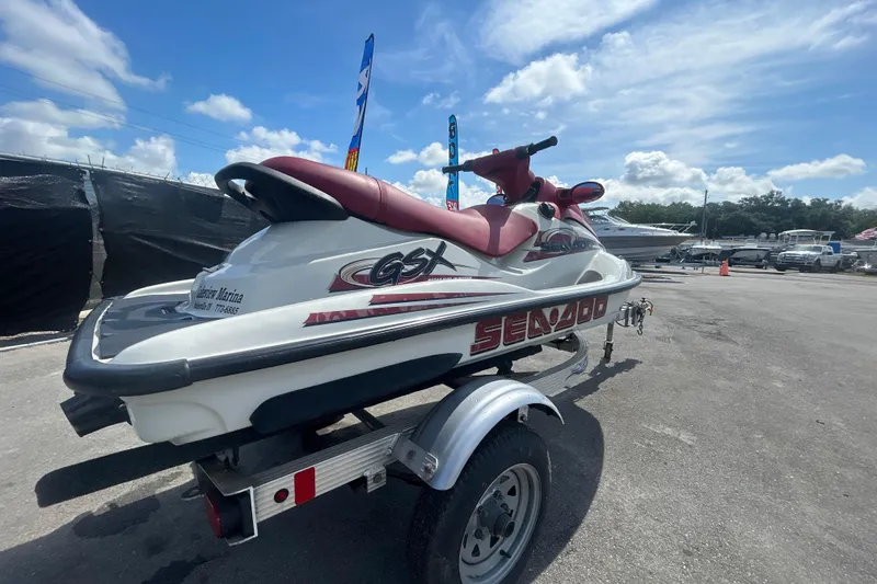 Slide: The Image of 1999 Sea Doo Jet Ski GSX on trailer under blue sky. - 3