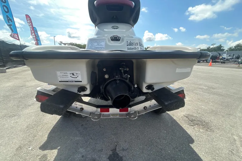 Slide: The Image of 1999 Sea Doo Jet Ski on trailer, rear view, parked outdoors under blue sky. - 5