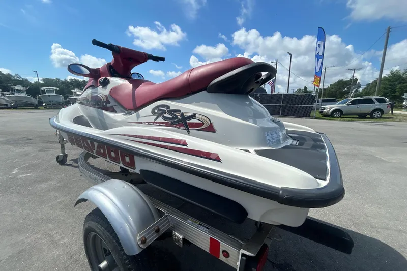 Slide: The Image of 1999 Sea Doo Jet Ski GSX on trailer, parked outdoors under a blue sky. - 6