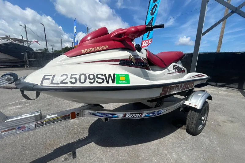 Slide: The Image of 1999 Sea Doo Jet Ski on trailer, white with red seat, Florida registration. - 8