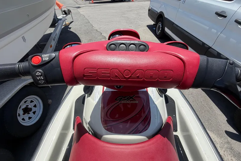 Slide: The Image of 1999 Sea Doo Jet Ski handlebars with red grips and control buttons. - 9