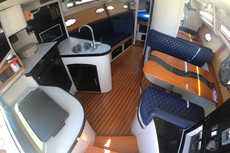 Slide: The Image of Interior of a 1989 Navigator 34 Flybridge yacht with modern kitchen and seating area. - 12