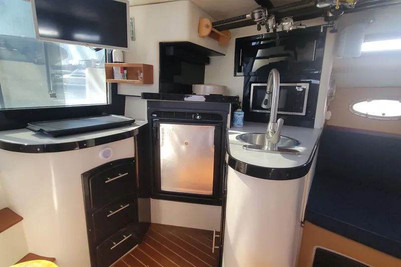 Slide: The Image of Compact kitchen area in a 1989 Navigator 34 Flybridge yacht with modern amenities. - 14