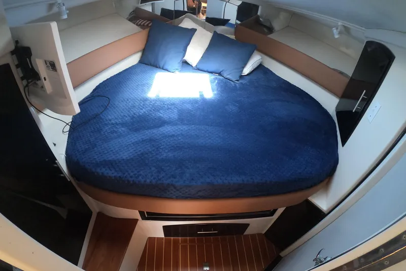 Slide: The Image of Cozy cabin interior of 1989 Navigator 34 Flybridge with blue bedding and pillows. - 16
