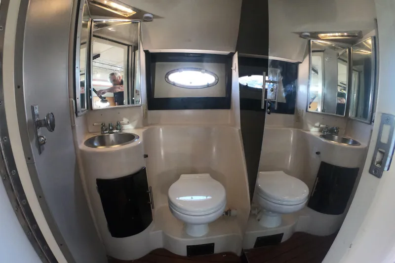 Slide: The Image of Bathroom interior of 1989 Navigator 34 Flybridge yacht, featuring sink, toilet, and mirror. - 17