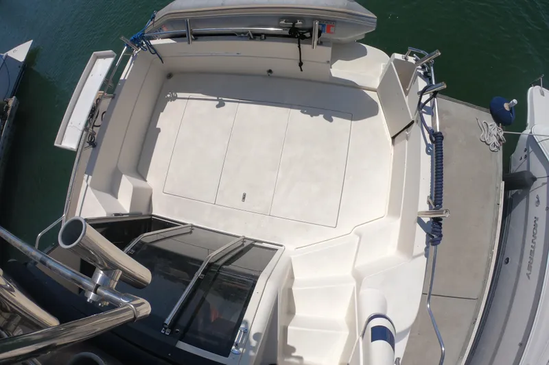 Slide: The Image of 1989 Navigator 34 Flybridge boat deck, spacious layout, docked at marina. - 9