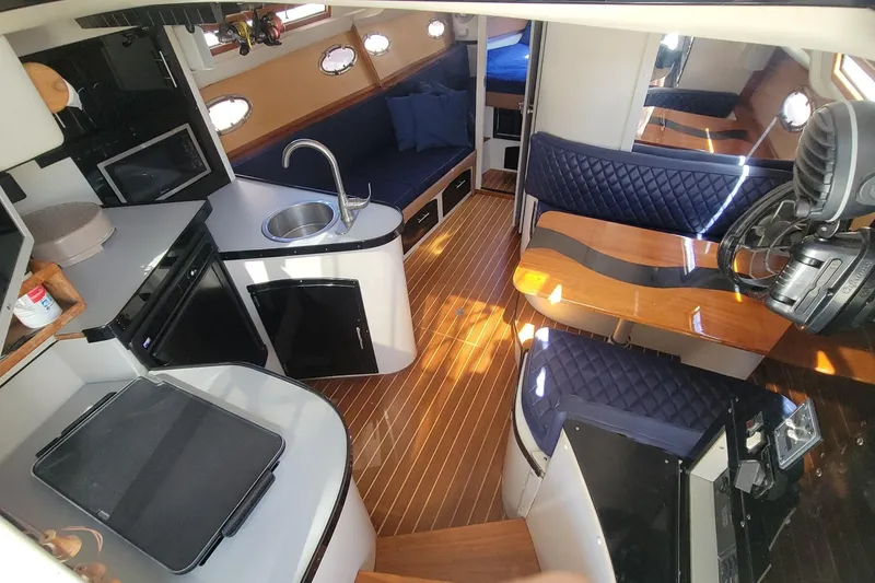 Slide: The Image of Interior of 1989 Navigator 34 Flybridge yacht with modern kitchen and seating area. - 14