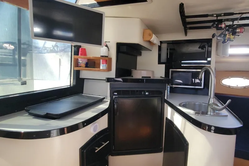 Slide: The Image of Interior of 1989 Navigator 34 Flybridge yacht with modern kitchen amenities. - 16
