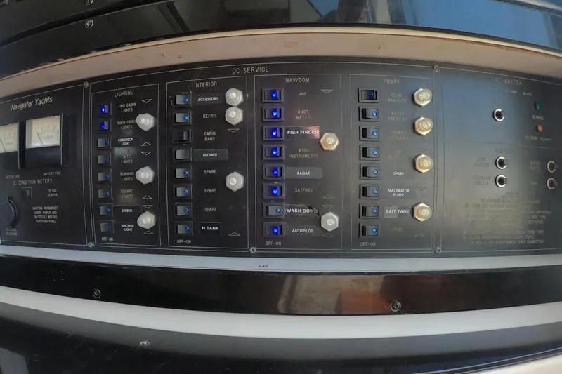 Slide: The Image of Control panel of a 1989 Navigator 34 Flybridge yacht with various switches and indicators. - 24