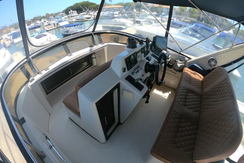 Slide: The Image of Cockpit of 1989 Navigator 34 Flybridge yacht with steering wheel and navigation equipment. - 4