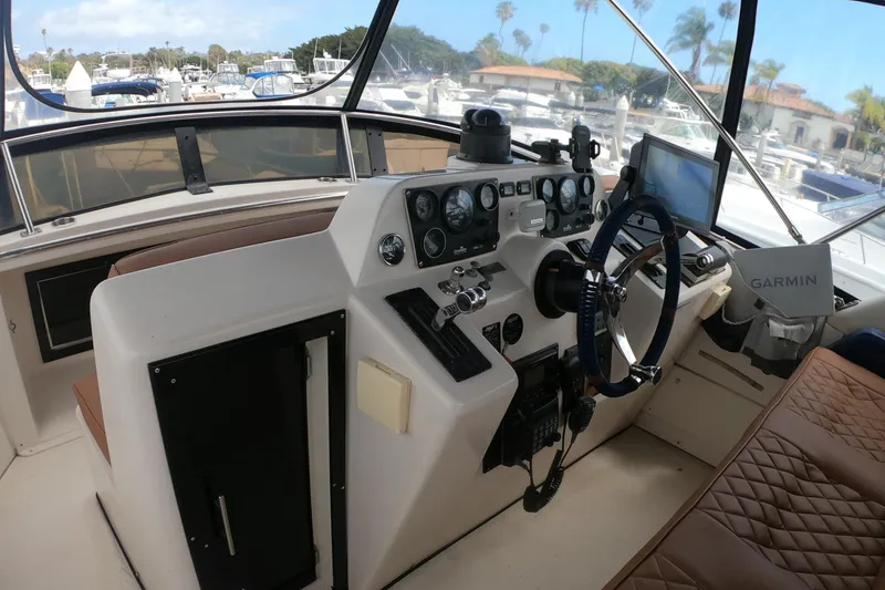 Slide: The Image of Cockpit of 1989 Navigator 34 Flybridge with steering wheel, gauges, and Garmin navigation system. - 5