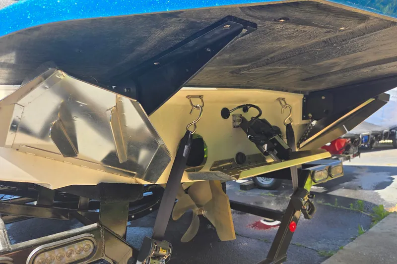Slide: The Image of 2022 MasterCraft NXT24 boat underside showing components and trailer details. - 13
