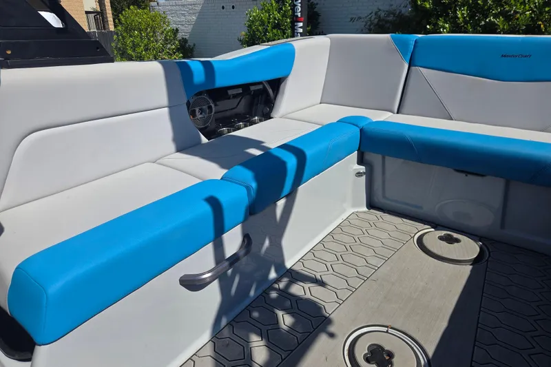 Slide: The Image of 2022 MasterCraft NXT24 boat interior with blue and gray seating, modern design. - 8