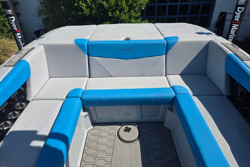 Slide: The Image of 2022 MasterCraft NXT24 boat interior with blue and gray seating, showcasing modern design. - 9