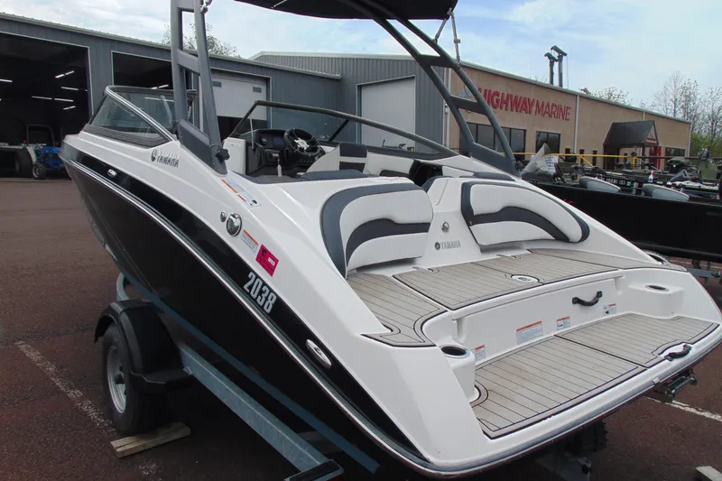 Slide: The Image of 2021 Yamaha Boats AR195 on trailer, displayed at Highway Marine dealership. - 4