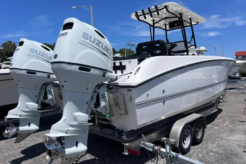 The Image of 2023 Twin Vee 240 GFX CC boat with dual Suzuki engines on a trailer. - 0