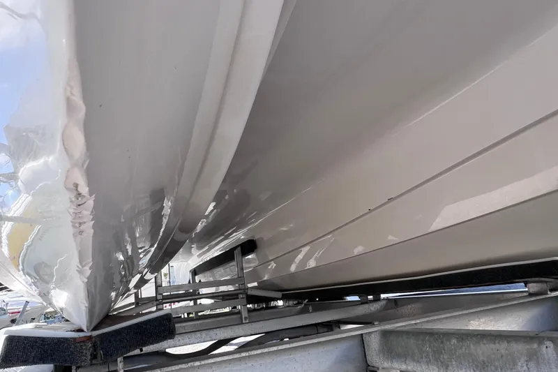 Slide: The Image of 2023 Twin Vee 240 GFX CC boat hull on trailer, close-up view. - 10
