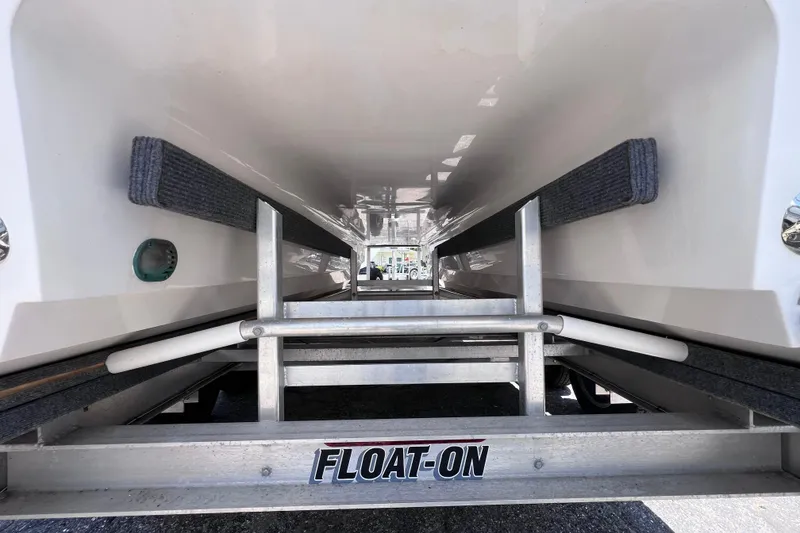 Slide: The Image of Underneath view of 2023 Twin Vee 240 GFX CC boat on a Float-On trailer. - 11