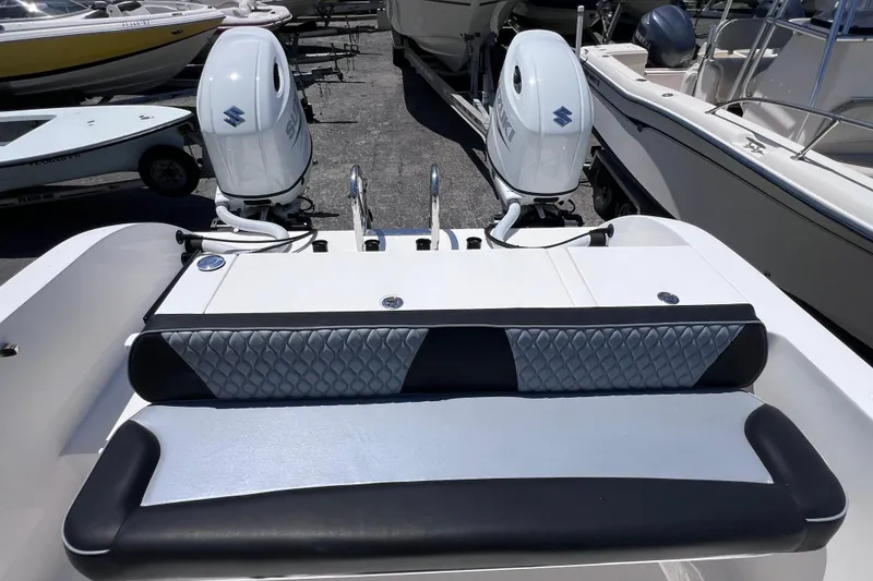 Slide: The Image of 2023 Twin Vee 240 GFX CC boat with dual Suzuki outboard motors and cushioned seating. - 14