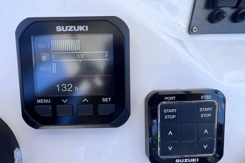 Slide: The Image of Suzuki boat control panel on 2023 Twin Vee 240 GFX CC, showing fuel levels and engine hours. - 23