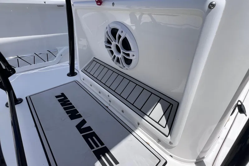 Slide: The Image of 2023 Twin Vee 240 GFX CC boat interior with speaker and branded flooring. - 28