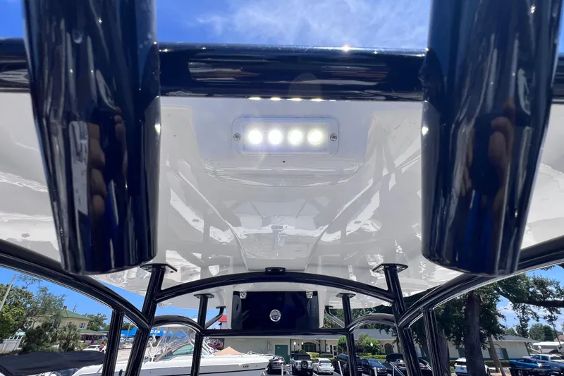 Slide: The Image of 2023 Twin Vee 240 GFX CC boat with T-top and LED lights under clear sky. - 33