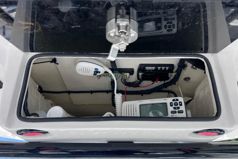 Slide: The Image of 2023 Twin Vee 240 GFX CC boat console with communication equipment and wiring. - 34