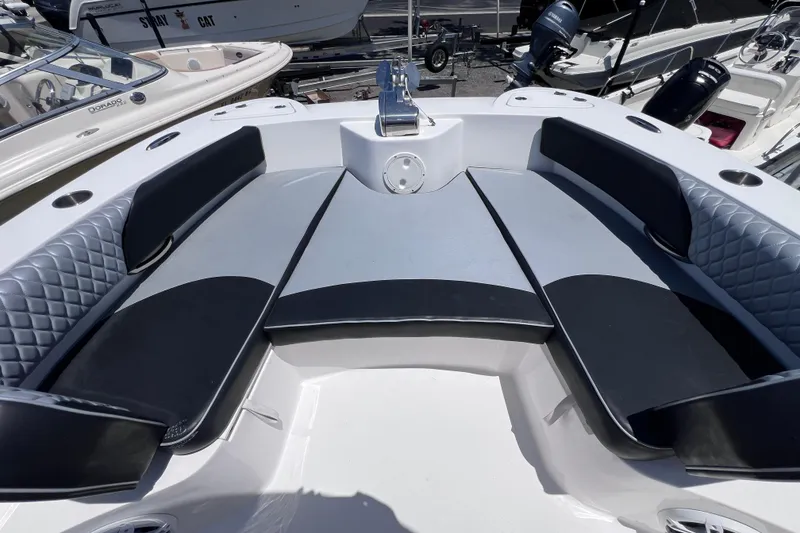 Slide: The Image of 2023 Twin Vee 240 GFX CC boat interior with cushioned seating and sleek design. - 38