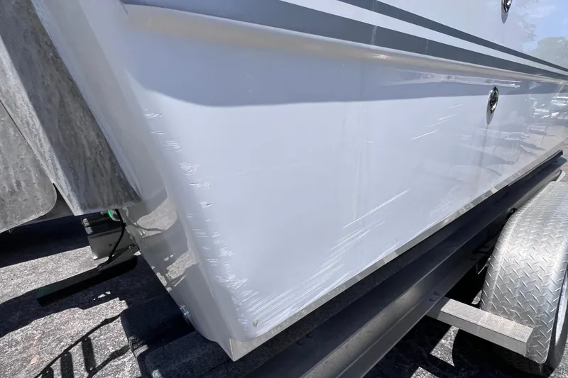 Slide: The Image of 2023 Twin Vee 240 GFX CC boat hull with visible scratches on trailer. - 4