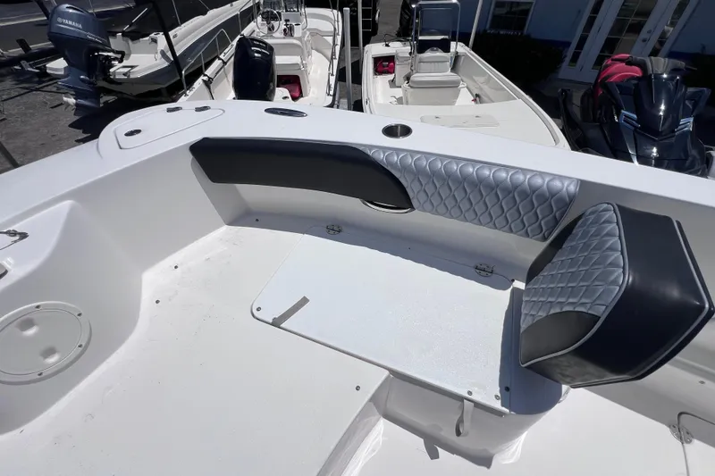 Slide: The Image of 2023 Twin Vee 240 GFX CC boat interior with cushioned seating and sleek design. - 44