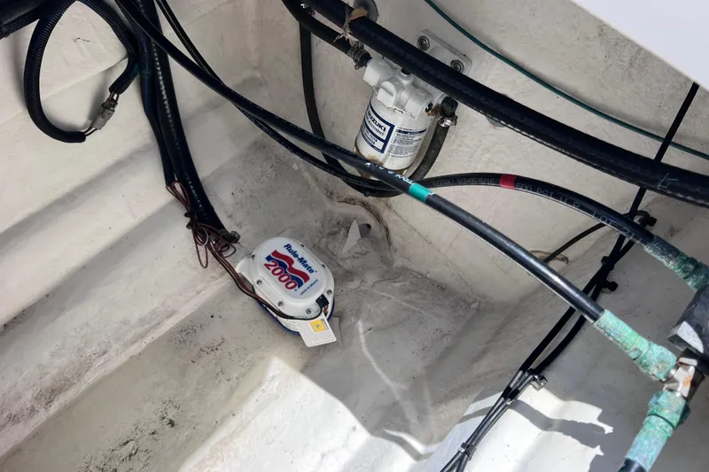 Slide: The Image of Bilge area of 2023 Twin Vee 240 GFX CC boat with Rule-Mate 2000 pump and wiring. - 49