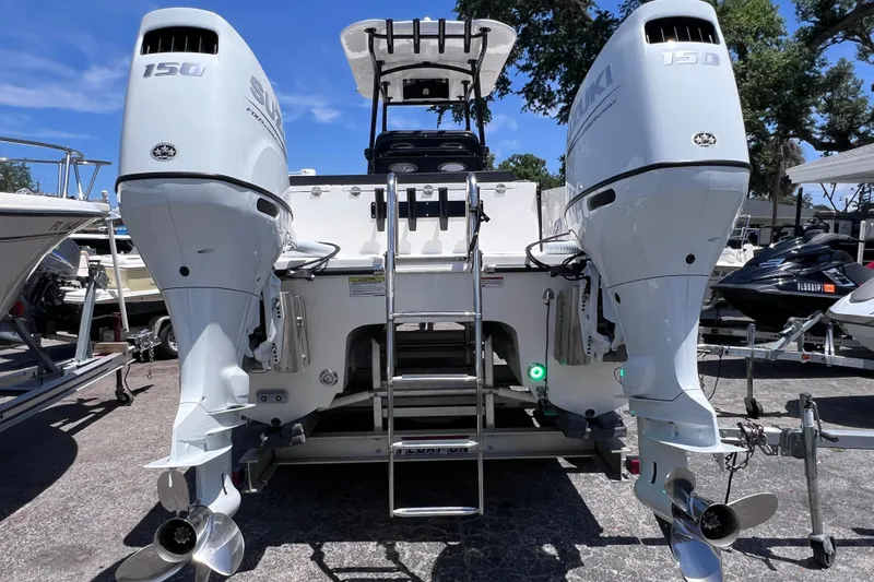 Slide: The Image of 2023 Twin Vee 240 GFX CC boat with dual Suzuki 150 outboard engines, rear view. - 5