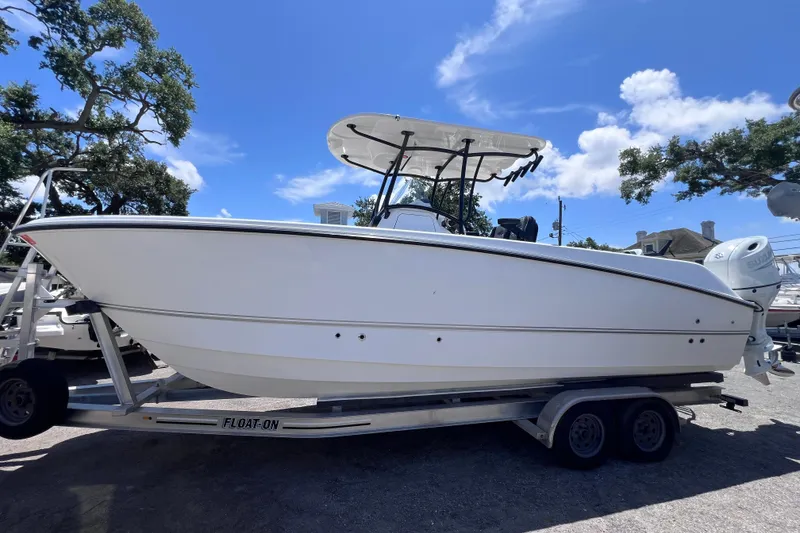 Slide: The Image of 2023 Twin Vee 240 GFX CC boat on trailer under clear blue sky. - 7