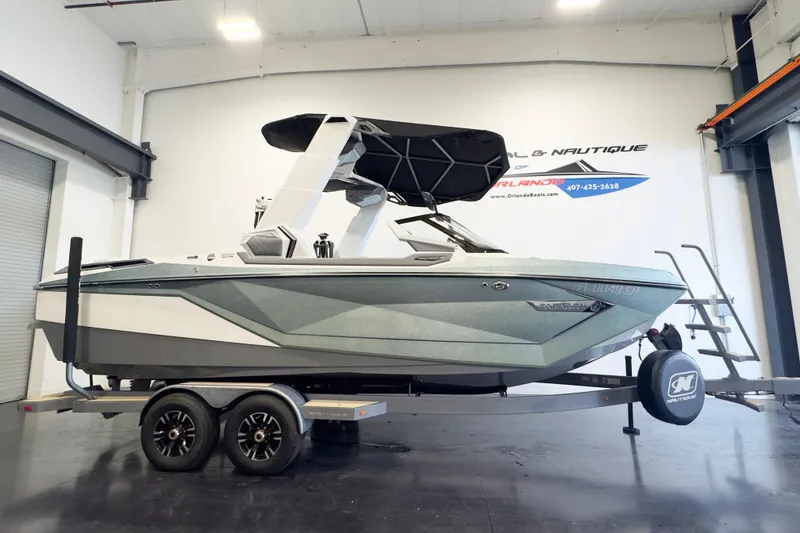 The Image of 2020 Nautique Super Air Nautique G23 Paragon boat on trailer in showroom. - 1