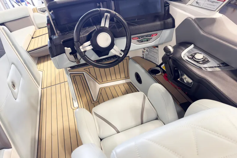 Slide: The Image of Interior of 2020 Nautique Super Air Nautique G23 Paragon boat, featuring sleek steering and controls. - 8
