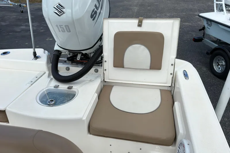 Slide: The Image of 2021 Sundance DX22 boat with Suzuki 150 engine, featuring beige and white seating. - 12