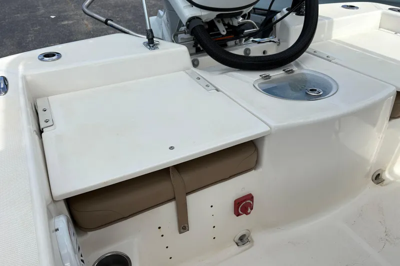 Slide: The Image of 2021 Sundance DX22 boat interior with storage compartment and livewell. - 13
