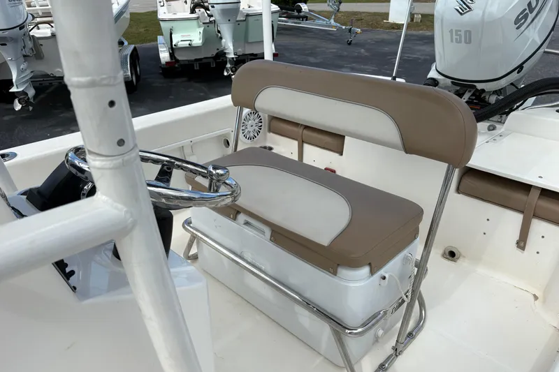 Slide: The Image of Interior of 2021 Sundance DX22 boat with steering wheel and seating. - 16