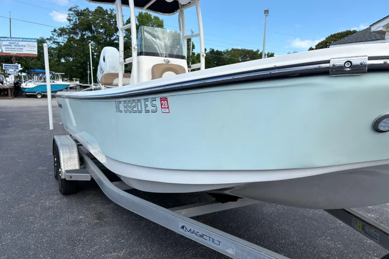 Slide: The Image of 2021 Sundance DX22 boat on trailer in outdoor setting. - 3