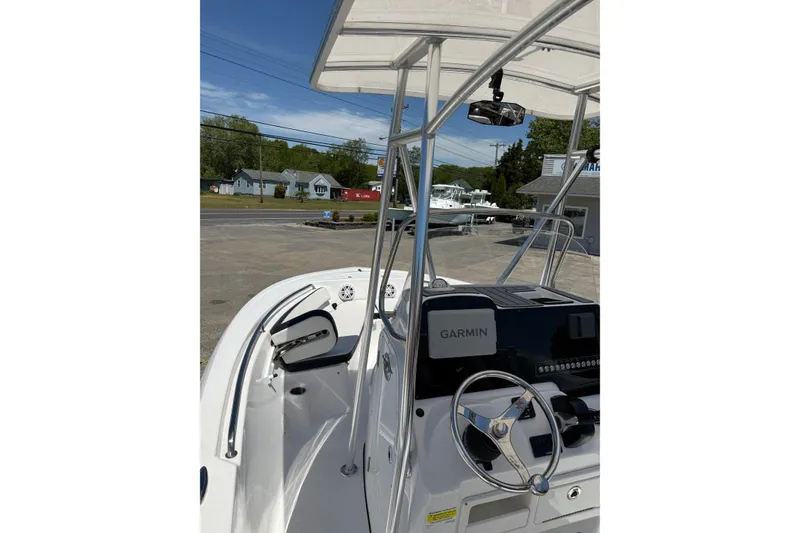 Slide: The Image of 2024 Tidewater 198 CC Adventure boat with Garmin navigation system, docked outdoors. - 12