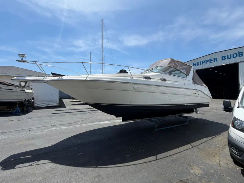 The Image of 1996 Sea Ray 290 Sundancer on a boat stand at Skipper Bud's. - 0