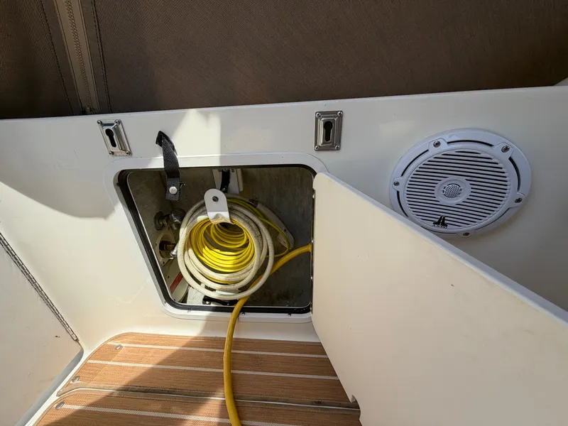 Slide: The Image of Storage compartment in 1996 Sea Ray 290 Sundancer with yellow cable. - 11