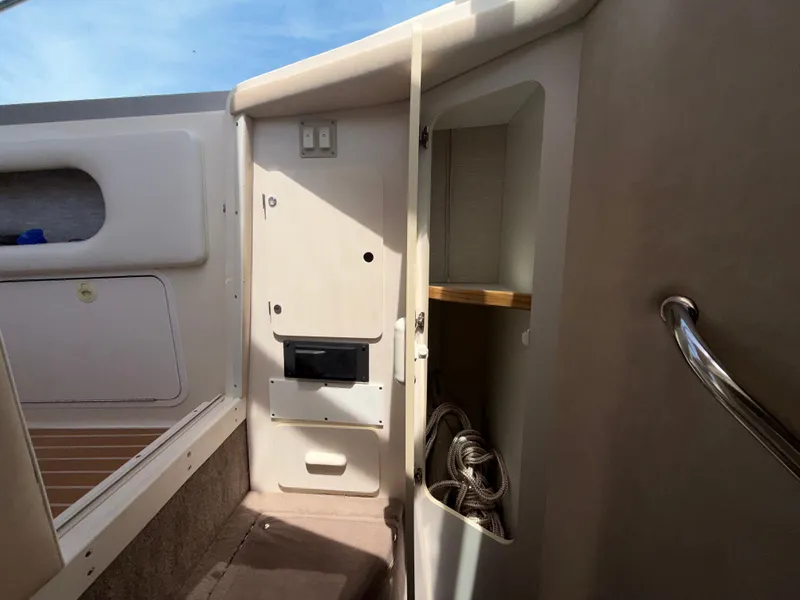 Slide: The Image of Interior of a 1996 Sea Ray 290 Sundancer with storage space. - 14
