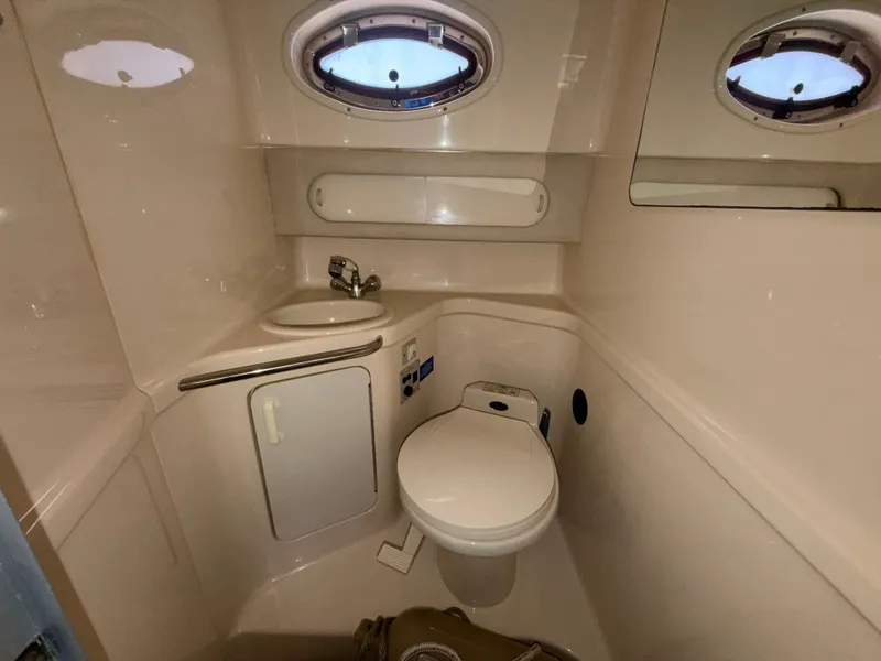 Slide: The Image of Interior view of a 1996 Sea Ray 290 Sundancer yacht bathroom. - 24