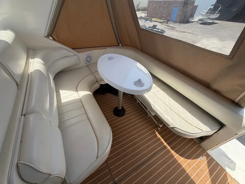 Slide: The Image of Interior of a 1996 Sea Ray 290 Sundancer with seating area and table. - 4