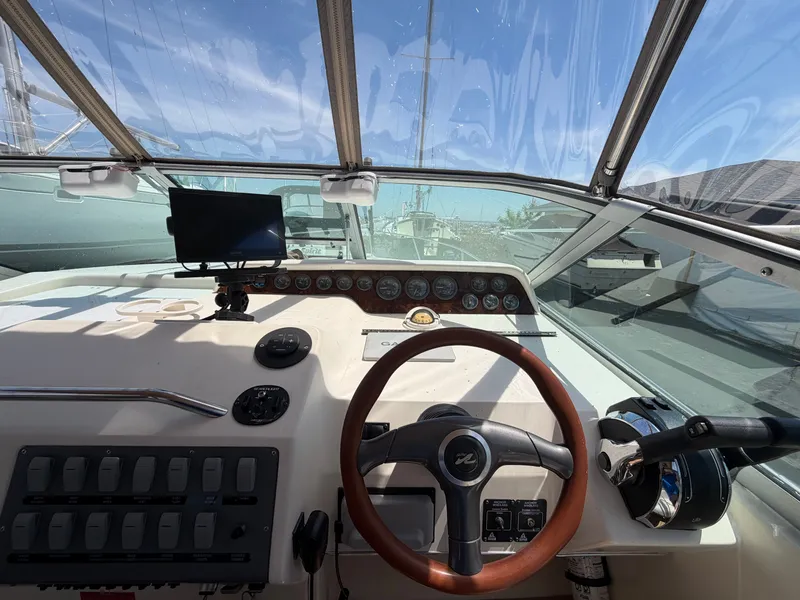 Slide: The Image of Cockpit of 1996 Sea Ray 290 Sundancer with steering wheel and instruments. - 7